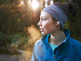 Woman jogging with wireless earphones